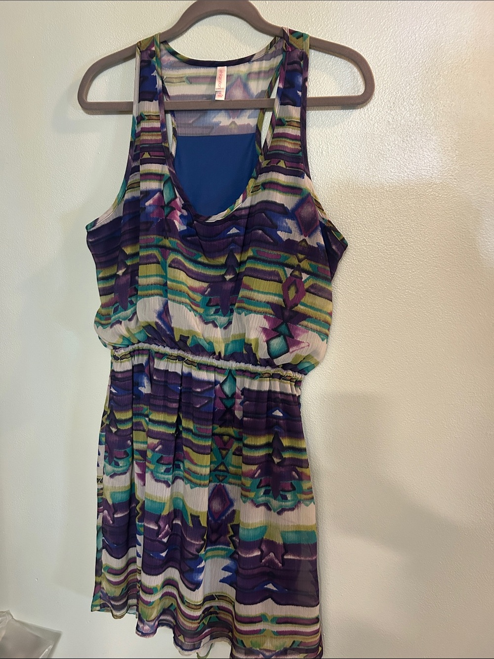 Women's patterned sheer top with label visible